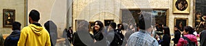 Visitors view and photograph the Mona Lisa