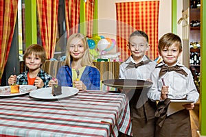 Visitors and waiters at the restaurant or cafe