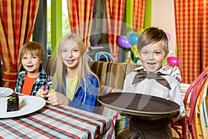 Visitors and waiters at the restaurant or cafe