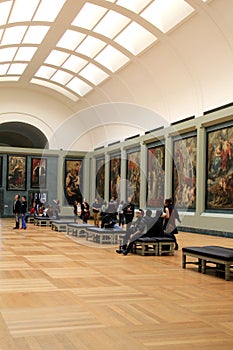 Visitors wandering through rooms filled with masterpieces,The Louvre,Paris,France,2016