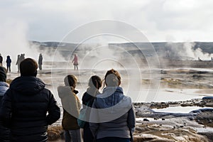 visitors watching geothermal springs without touching