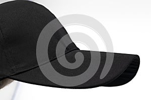 Visor of black plain cap for men isolated on a white background, side view,