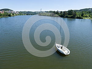 vista de cima do Rio Mondego em Coimbra com pequeno veleiro no canto inferior direito. photo