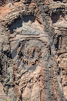 Texture view of huge sea rock, shadows and multiple rock layers photo