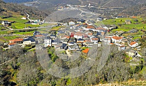 Vista panorÃÂ¡mica del pequeÃÂ±o pueblo de Cerdedelo entre montaÃÂ±as al comienzo de la primavera photo