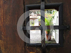 Vista A TravÃÂ©s De Ventana De Una Puerta Colonial photo