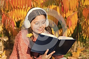 Visual and audio information. Schoolgirl study. Study every day. Girl read book autumn day. Little child enjoy learning