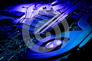 Macro Shot of Laptop RAM Modules and Cooling Fan on PCB with Blue and Purple Lighting