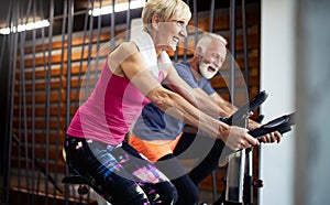 Vital mature couple exercising in the gym.