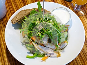 Vital salad with chicken breast, rucola, sesame seeds, vegetables