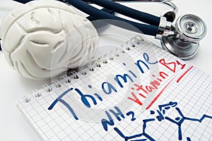 Vitamin B1 Thiamin concept photo. Stethoscope and brain figure lies next to inscription Vitamin B1 thiamin and vitamin chemical fo