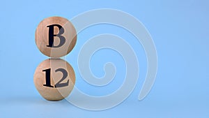 Vitamin B12 on wooden balls on a blue background