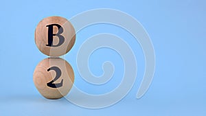 Vitamin B2 on wooden balls on a blue background