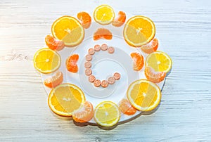 Vitamin C concept. Pills and citrus fruits on a plate