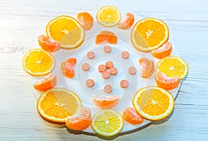 Vitamin C concept - pills and orange slices