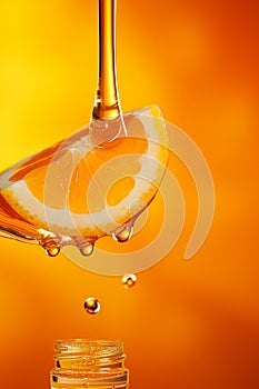 Vitamin C concept, transparent drop flows from orange into bottle
