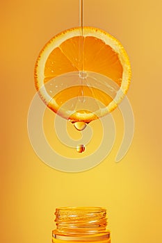 Vitamin C concept, transparent drop flows from orange into bottle