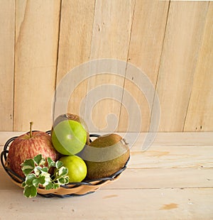 Vitamin C fruit apple, kiwi, lime in basket