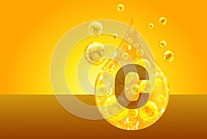 Vitamin C. Golden drops with oxygen bubbles. Health concept