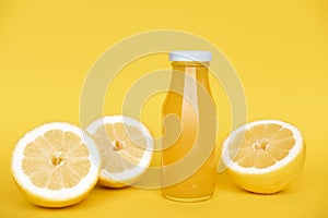 Vitamin c health remedy relief drink for cold and flu, with lemon, ginger and cinnamon spice and honey on yellow background.