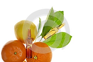 Vitamin C injection.A solution of vitamin C in brown ampoules set and citrus fruit isolated on white background.Health