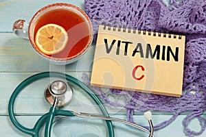 VITAMIN C lettering. Hot tea, knitted scarf and stethoscope