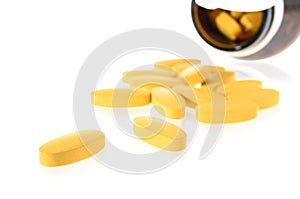 vitamin c pills in a clear glass bottle isolated on white background