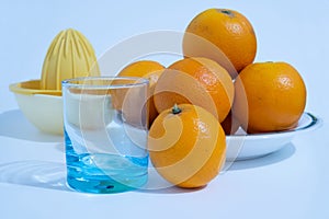 Vitamin C-rich fruit oranges in a ceramic dish.