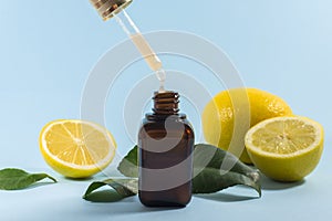 Vitamin C serum. Close up pipette with drop, citrus fruit essential oil. beauty care. Fresh lemons bio oil. Organic bio