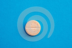 Vitamin C tablets on blue background ,winter protection from colds and flu ,food supplement