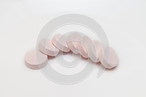 Vitamin C tablets pills on a white background
