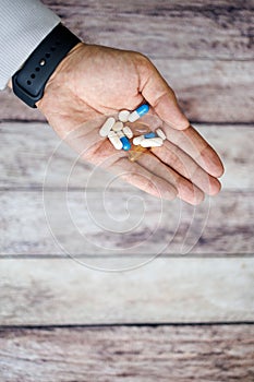 Vitamin capsules in hand, nutritional supplements and vitamins