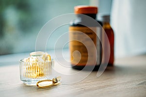 Vitamin D and Bone Health. Vitamin D yellow Soft capsules in glass bottle on table at home. Ways To Boost Vitamin D