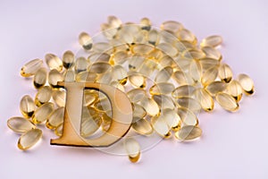 Vitamin D capsules on a white background. Close-up.