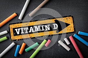 Vitamin D. Direction arrow with text on a dark chalkboard background