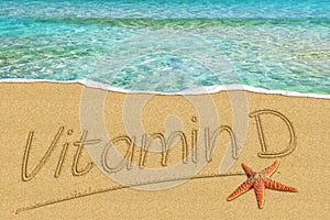 Vitamin D handwritten on the sand beach