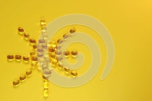 Vitamin D.Sun sign made from vitamin D capsules.gelatin capsules with vitamin D