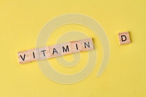 Vitamin d word written on wooden blocks.