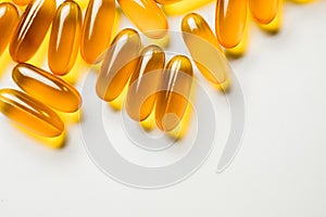 Vitamin e. Fish oil capsules on white background. Copy space for