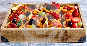 Vitamin fruit tartes with berries in basket