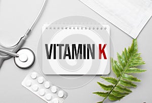Vitamin k word on notebook,stethoscope and green plant