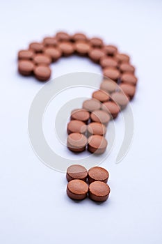 Vitamin medicine take dally health risk disease red pills question mark