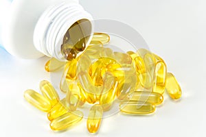 Vitamin Omega-3 fish oil capsules near a bottle