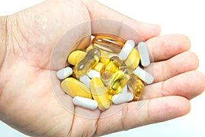 Vitamin and pill on hand.