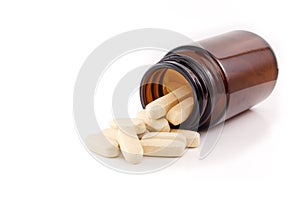 Vitamin pills view brown bottle on side