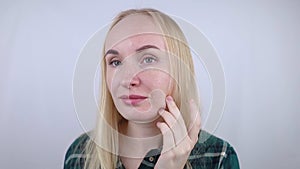 Vitamin A, Retinol, Niacinamide, Vitamin C. Girl smears her face with antioxidant anti-wrinkle cream. Anti-aging