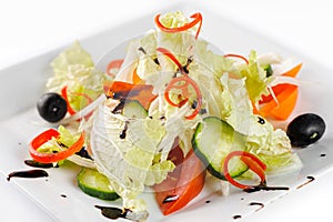 Vitamin salad with fresh vegetables on a white plate, closeup