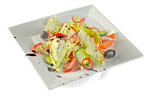 Vitamin salad with fresh vegetables on a white plate on white background, closeup