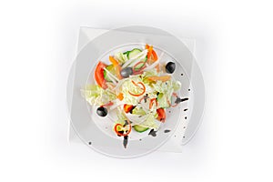 Vitamin salad with fresh vegetables on a white plate on white background, closeup