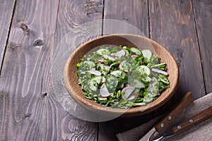 Vitamin salad of wild herbs with cucumber, radish and green onions